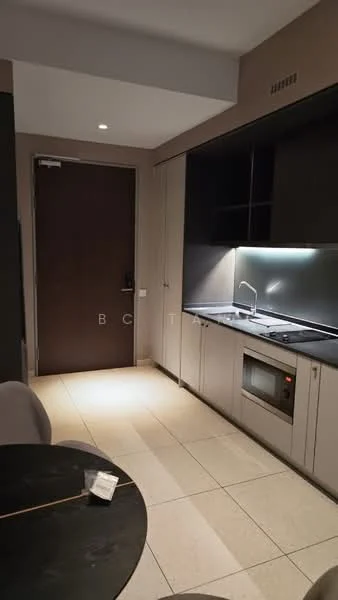 Kitchen features: dark cabinetry, light-colored countertop, built-in oven, stainless-steel sink, chrome faucet, tile flooring, recessed lighting, kitchen island, wall-mounted cabinets, open layout, door leading to hallway; style: modern.