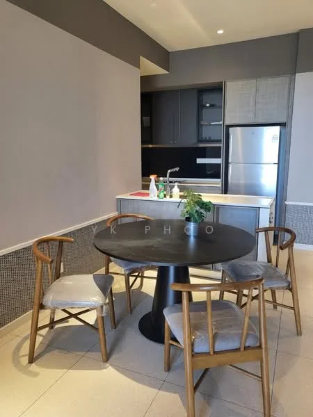 Dining features: round black dining table, 4 wooden dining chairs with grey upholstery, grey painted walls, light-colored tile flooring, kitchen cabinetry with dark finish, stainless-steel fridge, kitchen countertop with sink, decorative plant on table; style: modern.