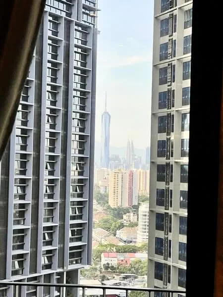 Exterior type: high-rise condominium; features: city skyline view, glass curtain wall, concrete facade, surrounded by urban landscape, adjacent buildings visible, tall structures in background; style: modern.