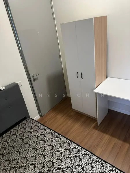 Room features: wooden flooring, white walls, grey upholstered sofa, white wardrobe with wooden accents, white desk, black and white patterned area rug, door with metallic handle; style: modern.