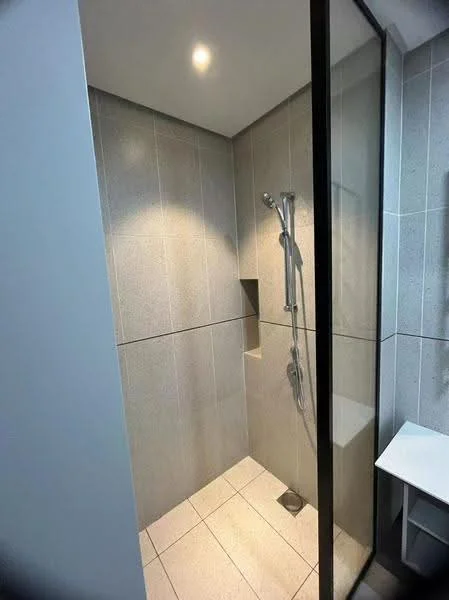 Bathroom features: walk-in shower with glass enclosure, rain shower head, handheld shower, tile cladding on walls, white ceramic tile flooring, built-in niche for toiletries, recessed lighting, modern shower controls; style: modern.