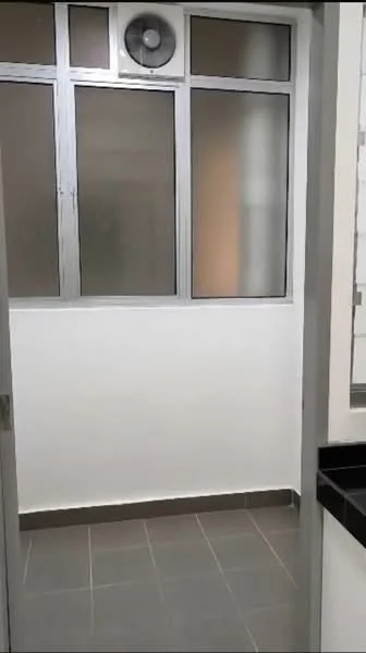 Room features: grey tiled flooring, white painted walls, large windows with frosted glass, metal window frames, wall-mounted fan, black countertop, light-colored cabinetry, no visible appliances; style: modern.