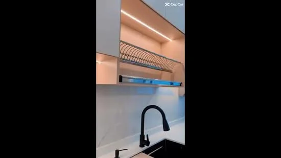 Kitchen features: black single-bowl stainless-steel sink, matte-black gooseneck faucet, white cabinetry with upper open shelving, under-cabinet LED lighting, white marble backsplash, black countertop, metal dish rack above sink; style: modern.