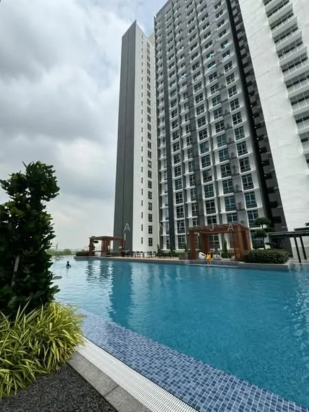 Exterior type: high-rise condominium; features: tall residential building, swimming pool, pool deck with loungers, landscaped garden with shrubs, water feature, modern facade with glass and concrete, balconies on upper floors, surrounded by greenery; style: modern.