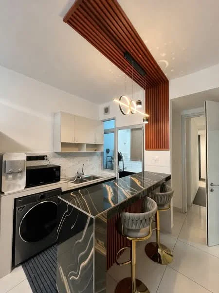 Kitchen features: white cabinetry, black marble countertop, stainless-steel sink, chrome pull-down faucet, built-in microwave, freestanding range oven, stainless-steel fridge, washer-dryer combo, pendant lighting, bar seating with gold stools, tile flooring, white backsplash with marble pattern, open layout, window for natural light; style: modern.