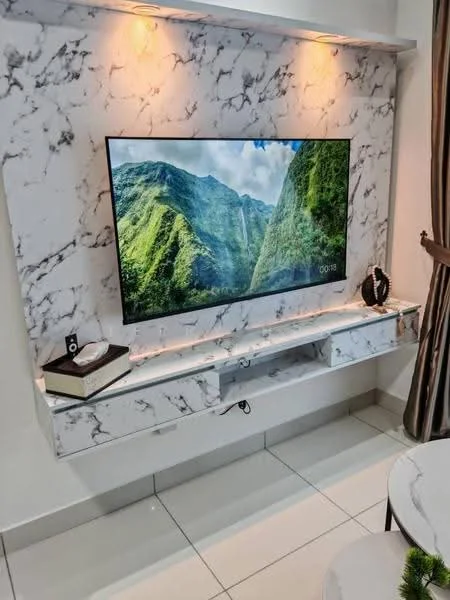 Living features: marble feature wall, wall-mounted TV, floating TV console, white cabinetry, recessed lighting, ceramic tile flooring, decorative plant, book on console, curtains, neutral color palette; style: modern.