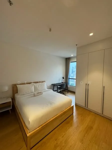 Bedroom features: queen-size bed with wooden frame, white bedding, two bedside lamps, wooden flooring, large window with city view, desk with chair, built-in wardrobe with sliding doors, neutral painted walls; style: modern; view: city.