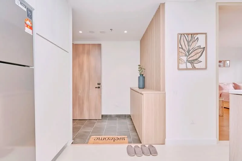 Room features: grey tile flooring, white walls, wood paneling on one wall, framed artwork on wall, welcome mat, interior door, recessed ceiling lights, shoe mat; style: modern.