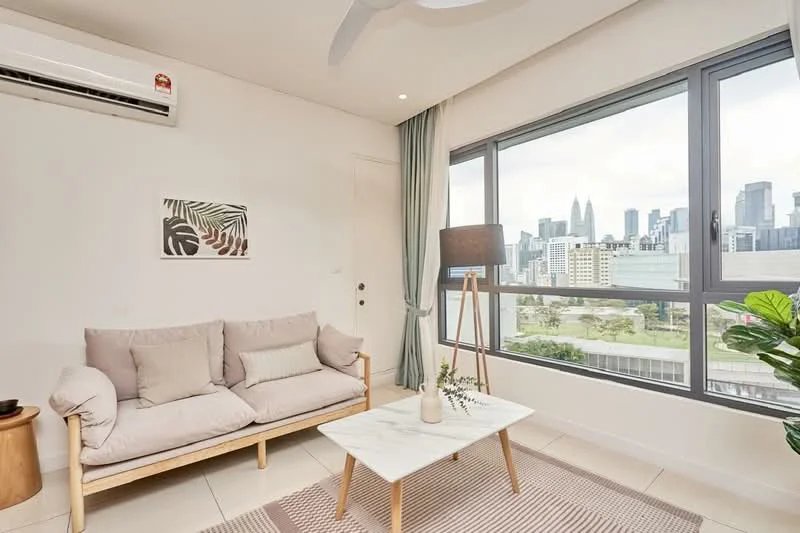 Living features: 3-seater fabric sofa in light beige, marble coffee table, area rug with geometric pattern, floor-to-ceiling windows, city skyline view, 1 wall-mounted split AC, light grey curtains, decorative floor lamp, indoor plant; style: modern; view: city.