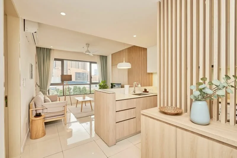 Living features: open-plan layout, floor-to-ceiling windows, light grey curtains, 3-seater fabric sofa in light beige, wooden coffee table, wooden side table, decorative plant in ceramic pot, pendant lamp, recessed downlights, light wood cabinetry, white countertop, stainless-steel sink, chrome pull-down faucet, kitchen island with storage, tile flooring; style: modern; view: city.