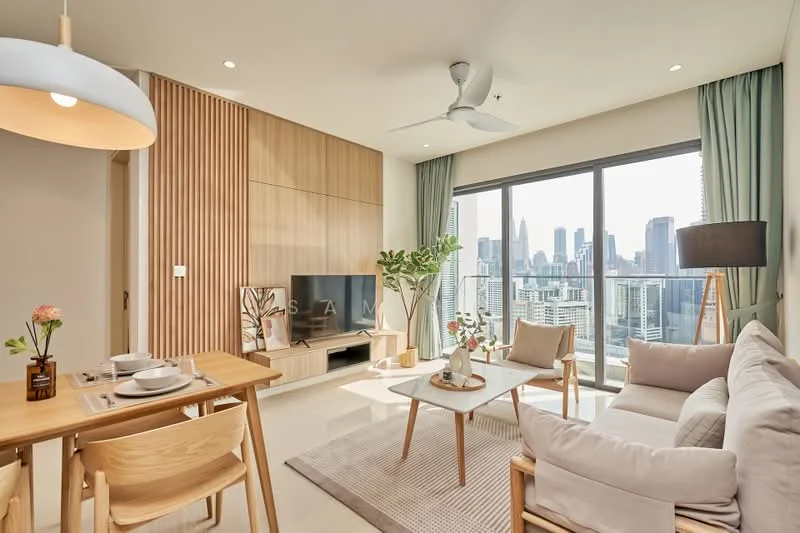 Living features: floor-to-ceiling windows, city skyline view, 3-seater fabric sofa in light beige, coffee table with white top, area rug with geometric pattern, TV console with wall-mounted TV, wooden accent wall, pendant lamp, ceiling fan, decorative plants, dining table for two with wooden chairs, light curtains, wall-mounted artwork; style: modern.