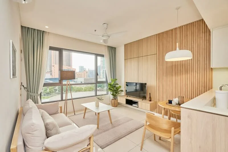 Living features: 3-seater fabric sofa in light grey, wooden coffee table, TV console with wall-mounted TV, area rug with neutral color, floor-to-ceiling windows, curtains in light green, ceiling fan, pendant light, wood panel accent wall, indoor plant in ceramic pot, decorative wall art, open shelving with decorative items; style: modern; view: city.