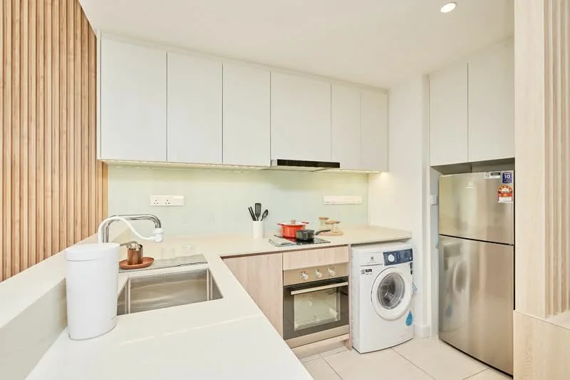 Kitchen features: white cabinetry, light wood paneling, white quartz countertop, stainless-steel sink, chrome pull-down faucet, built-in oven, 4-burner gas hob, stainless-steel range hood, front-load washing machine, stainless-steel fridge, glass backsplash, kitchen utensils on countertop, under-cabinet lighting, tile flooring; style: modern.