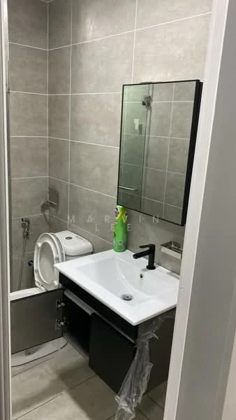 Bathroom features: grey tiled walls, white ceramic floor tiles, single-sink vanity with black cabinet, chrome basin mixer faucet, framed mirror, one-piece toilet, handheld shower, shower enclosure, toilet paper holder, cleaning product on countertop; style: modern.