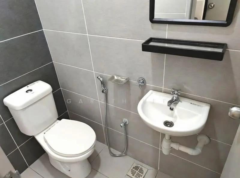 Bathroom features: white one-piece toilet, chrome basin mixer faucet, white pedestal sink, shower with handheld showerhead, grey wall tiles, light grey floor tiles, mirror above sink, black wall-mounted shelf; style: modern.