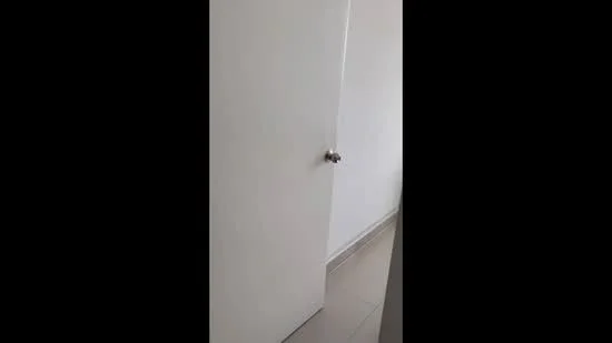 Room features: white painted walls, light-colored floor tiles, door with round knob.