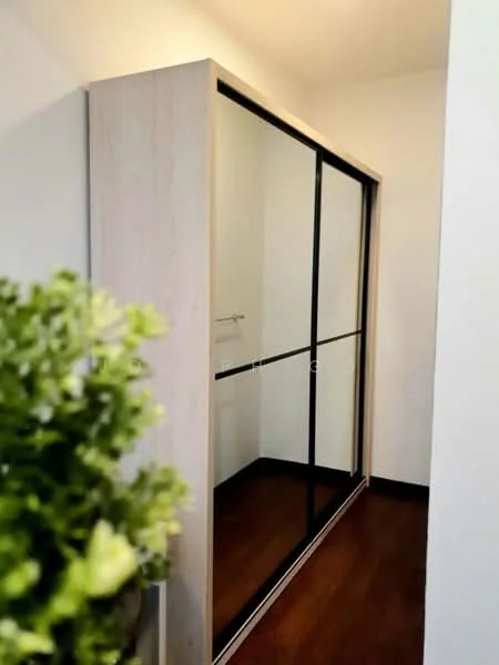 Room features: built-in wardrobe with sliding glass doors, wooden frame, black metal accents, dark wood flooring, white walls, decorative plant in ceramic pot; style: modern.