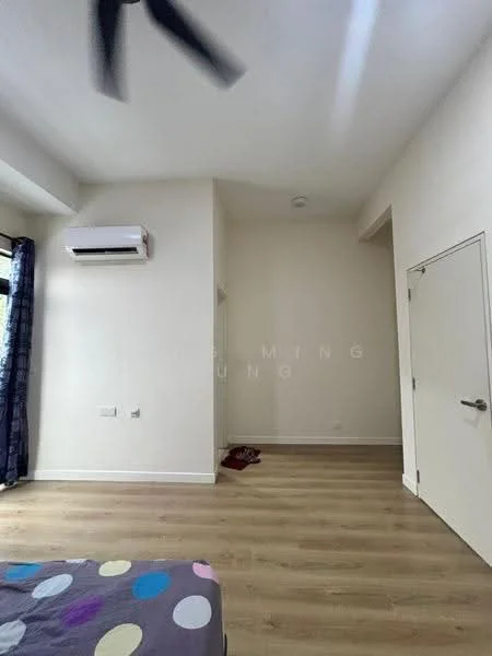 Room features: light wood flooring, white painted walls, 1 wall-mounted split AC, ceiling fan, door, window with curtains, corner of room with no visible furniture.