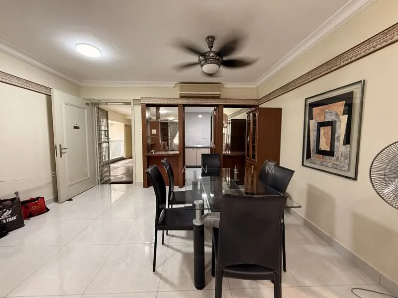 Dining features: glass dining table, black dining chairs, ceiling fan with light, white tiled flooring, wall-mounted artwork, built-in wooden cabinetry, crown moulding, recessed ceiling light; style: modern. Room features: white painted walls, doorway leading to another room, open layout.