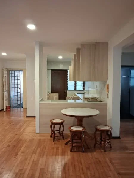 Kitchen features: wooden flooring, white painted walls, kitchen island with round marble top, three wooden stools, glass backsplash, built-in cabinets with wood finish, recessed downlights, open layout to living area, countertop with overhang for seating; style: modern. Room features: wooden flooring, white painted walls, doorway leading to another room, light fixtures.