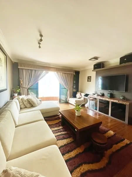Living features: L-shape sectional sofa in cream, wood coffee table, area rug with geometric pattern, wall-mounted TV, TV console, floor-to-ceiling windows, sheer curtains, dark accent wall, recessed downlights, decorative wall art, potted plant, wood flooring; style: contemporary; view: city.