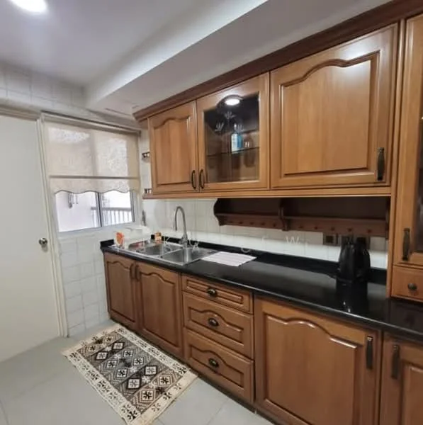 Kitchen features: wood cabinetry with dark finish, black granite countertop, single-bowl stainless-steel sink, chrome pull-down faucet, built-in wall cabinet with glass doors, tile backsplash, ceramic tile flooring, recessed downlights, window with sheer curtains, kettle, black countertop appliances, decorative rug; style: traditional.