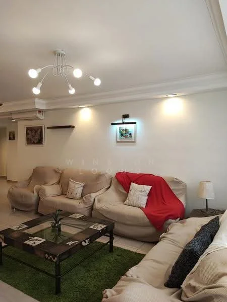 Living features: 2-seater fabric sofa in beige, 3-seater fabric sofa in beige, red throw blanket, glass coffee table, area rug in green, wall-mounted light fixture, recessed lighting, decorative wall art, shelf on wall, table lamp; style: contemporary.