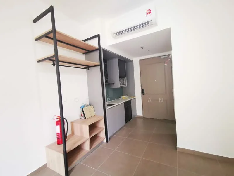 Room features: open shelving unit with wooden shelves and black metal frame, built-in kitchen cabinetry in grey, countertop in kitchen area, fire extinguisher on display, tile flooring in light brown, wall-mounted air conditioning unit, main entrance door, light-colored walls; style: modern.