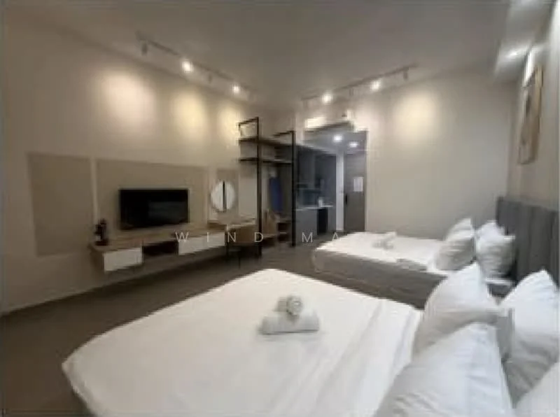 Room features: two queen-size beds with white bedding, grey upholstered headboard, wooden bedside table, wall-mounted TV, floating TV console, recessed lighting, light grey walls, carpeted flooring, mirror on wall, open shelving unit, kitchenette visible in background; style: modern.