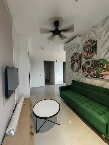 Living features: green fabric sofa, round coffee table with black metal legs, wall-mounted TV, ceiling fan, air conditioning unit, decorative wall art with tropical theme, light-colored tiled flooring, white painted walls, accent wall with marble pattern; style: modern.
