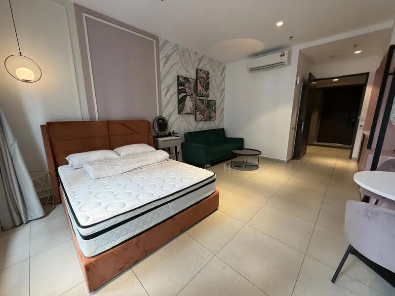 Room features: queen-size bed with upholstered headboard, mattress on bed frame, green fabric sofa, round coffee table, wall-mounted air conditioning unit, light fixture with pendant design, decorative wall art with floral patterns, light-colored tiled flooring, curtains on window, wall with textured wallpaper, entrance door visible, small dining table with chairs; style: modern.