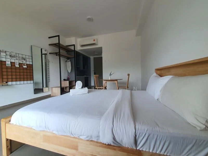 Bedroom features: king-size bed with white bedding, wooden bed frame, wall-mounted mirror, open shelving unit, wall-mounted coat rack, air conditioning unit, floor-to-ceiling window, grey concrete flooring, white painted walls, desk and chair, small kitchenette visible in background; style: minimalist.