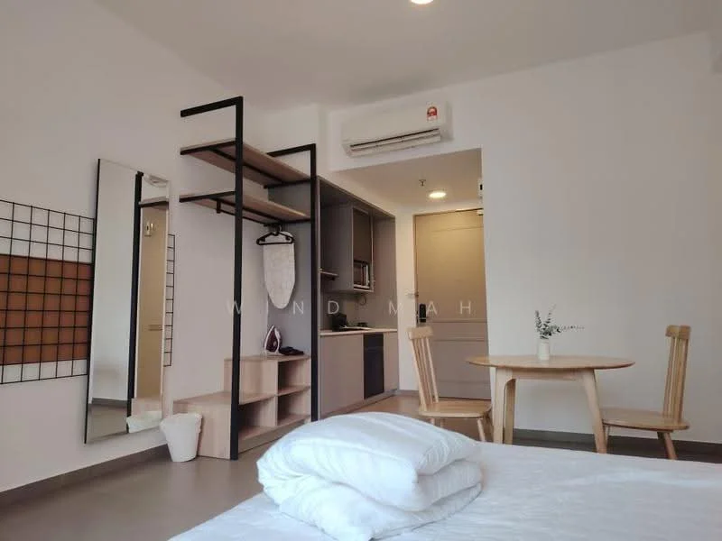 Room features: white painted walls, grey flooring, 1 wall-mounted split AC, built-in shelving unit, round dining table, 2 wooden dining chairs, mirror on wall, small vase with plant, kitchenette with cabinets, recessed ceiling lights; style: modern.