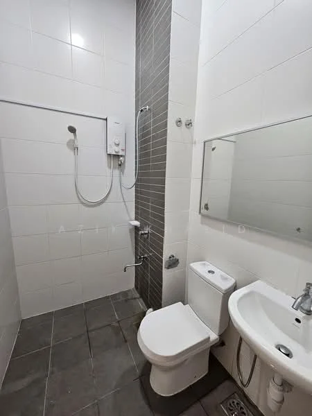 Bathroom features: white tiled walls, grey tiled flooring, walk-in shower with glass partition, chrome shower head, wall-mounted shower controls, toilet with dual flush, sink with chrome faucet, framed mirror above sink, shower wall with grey tiles, white sink, towel rail, drainage grate on floor; style: modern.