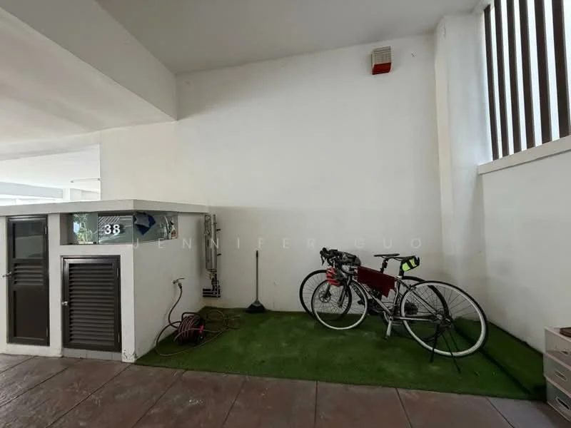 Exterior features: green artificial grass flooring, white painted walls, bicycle rack, two bicycles, exposed electrical outlet, hose reel, corner space; style: modern.
