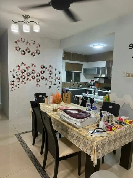 Dining features: dining table with tablecloth, black dining chairs, pendant light fixture, decorative wall with floral pattern, cream tiled flooring, open layout to kitchen, wall-mounted cabinets in kitchen, kitchen countertop visible, multiple kitchen appliances visible, wall clock, decorative items on table; style: modern. Kitchen features: kitchen cabinets, kitchen countertop, stainless-steel sink, multiple kitchen appliances, open layout to dining area; style: modern.