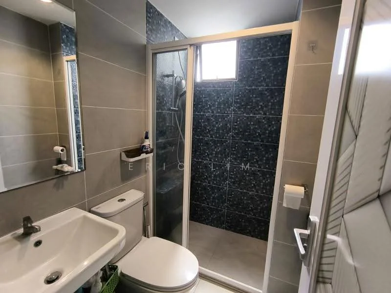 Bathroom features: grey tiled walls, blue mosaic tile accent wall, white ceramic sink, chrome basin mixer faucet, one-piece toilet, walk-in shower with glass enclosure, rain shower head, wall-mounted mirror, towel holder, window for natural light, white tiled flooring; style: modern.