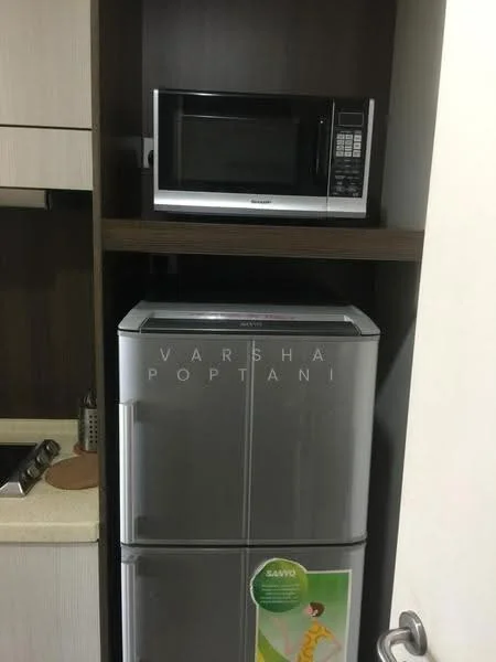 Kitchen features: stainless-steel fridge, microwave, wood cabinetry, granite countertop, kitchen sink, kitchen faucet; style: modern.