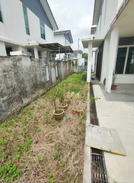 Exterior type: linked terrace house; features: manicured lawn, concrete pathway, fenced yard, potted plants, exposed concrete wall, adjacent houses visible, drainage system, grass area; style: modern.