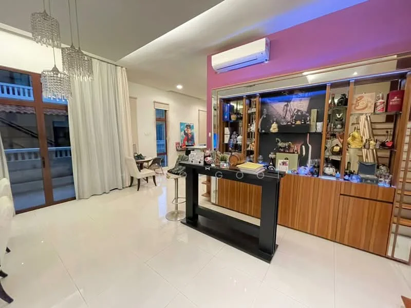 Living features: white painted walls, glossy tile flooring, recessed downlights, 5-blade ceiling fan, large windows with sheer curtains, wooden display cabinet, bar counter with stools, decorative items on shelves, air conditioning unit; style: modern.