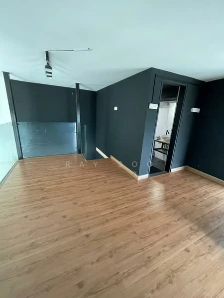 Room features: dark painted walls, wooden flooring, track lighting, glass partition, doorway leading to another room, corner layout, no visible furniture; style: modern.