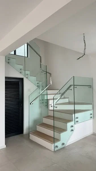 Room features: glass staircase with stainless steel handrail, white painted walls, light-colored flooring, recessed lighting, modern design, open space, black door with horizontal slats, large windows allowing natural light; style: modern.