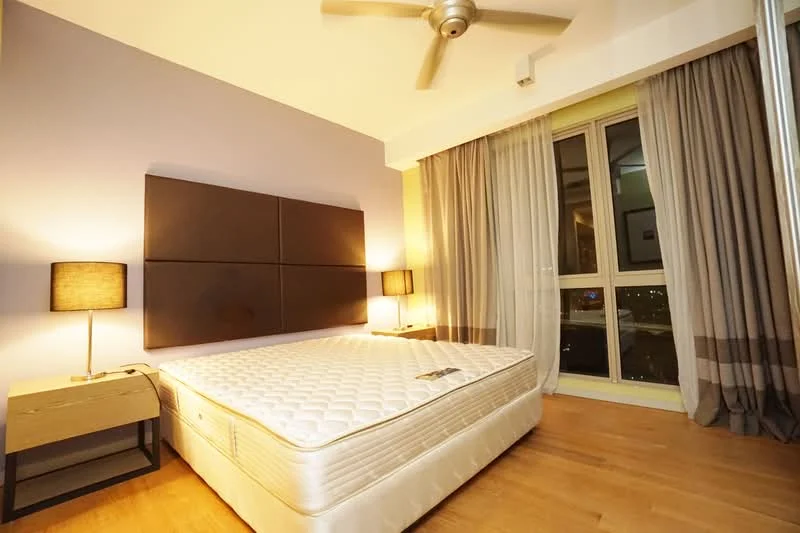 Bedroom features: queen-size bed, upholstered headboard, 2 bedside lamps, wooden bedside table, floor-to-ceiling windows, sheer curtains, blackout curtains, wooden flooring, 5-blade ceiling fan with light, decorative wall panels, city view; style: modern; view: city.