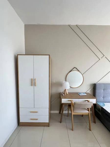 Bedroom features: grey upholstered bed, white wardrobe with wooden handles, wooden desk with drawers, white chair, round mirror, table lamp, cream painted walls, glossy tile flooring; style: modern.