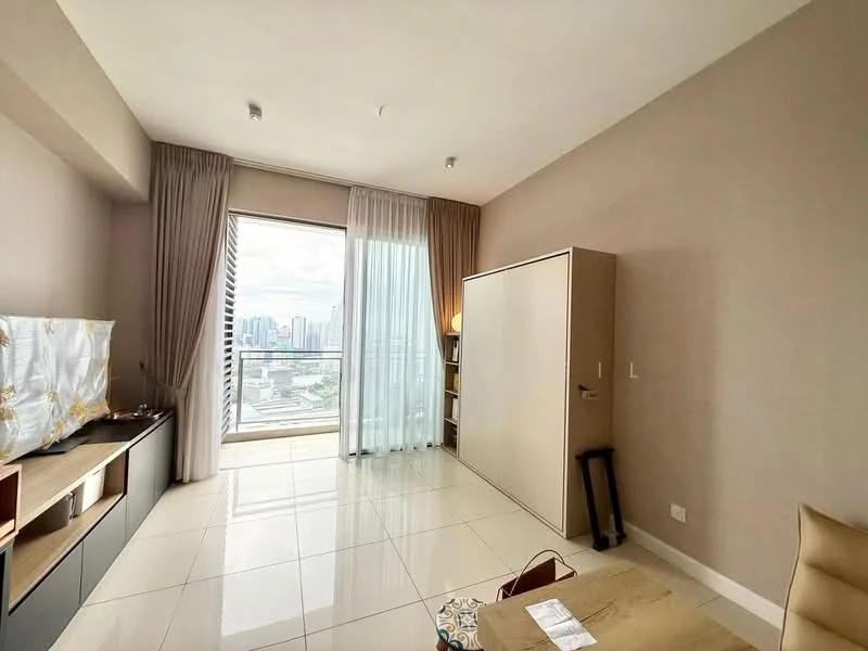 Room features: light beige painted walls, white ceiling, large floor-to-ceiling window, sheer curtains, tile flooring, built-in wardrobe, TV console, wall-mounted TV, small coffee table, bookshelf, decorative items on shelves; style: modern; view: city.