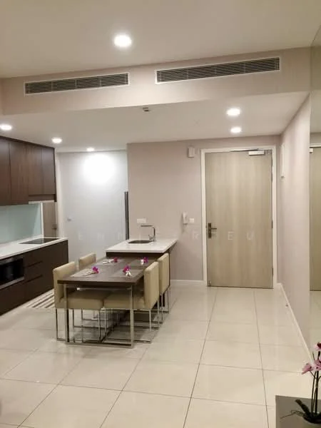 Dining features: rectangular dining table with four chairs, white ceramic tile flooring, brown wooden cabinetry, built-in microwave, stainless-steel sink, chrome faucet, recessed downlights, wall-mounted air conditioning unit, neutral painted walls, door leading to hallway, mirror on wall; style: modern.