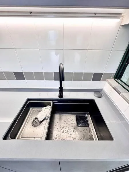 Kitchen features: double-bowl stainless-steel sink, matte-black gooseneck faucet, grey countertop, white tiled backsplash, grey tile accents, drainage tray, water droplets on sink, window view; style: modern.