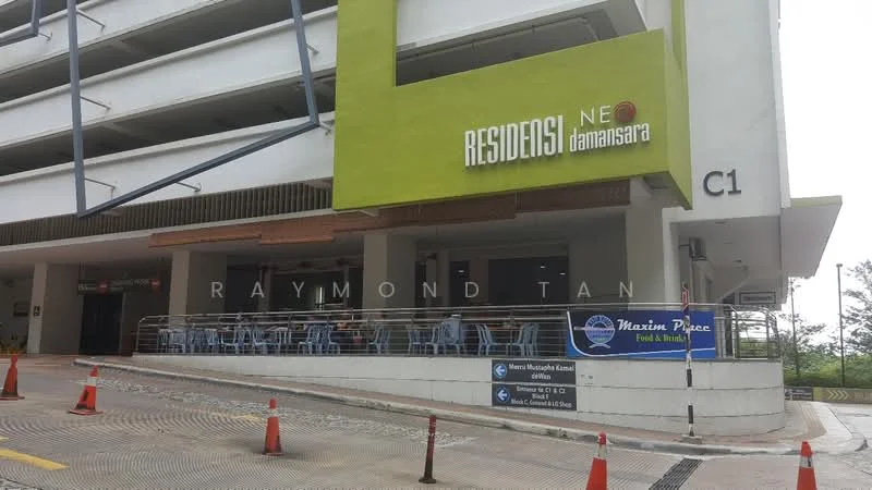 Exterior type: mid-rise condominium; features: green accent facade, concrete structure, outdoor seating area, signage for 'Residensi Neo Damansara', covered entrance, parking area, surrounding landscaping, multiple levels visible; style: modern.