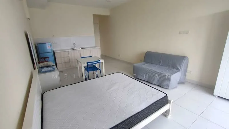 Room features: white painted walls, white tiled flooring, single bed frame without mattress, grey fabric sofa, blue dining chair, small dining table, kitchenette with sink, stainless-steel fridge, built-in cabinetry, open layout; style: modern.