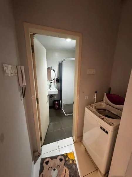 Laundry features: front-load washing machine, tile flooring, light grey painted walls, mirror on wall, shower enclosure, white door, bathroom vanity with sink, decorative rug with bear design.
